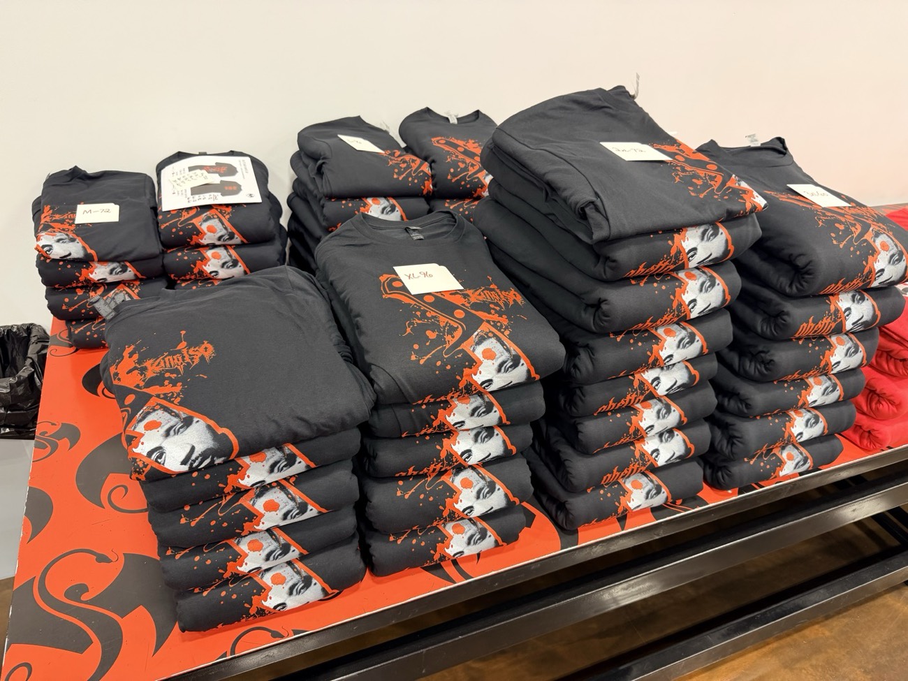 Strange Wid' It Tour 2026 printed merch on the table